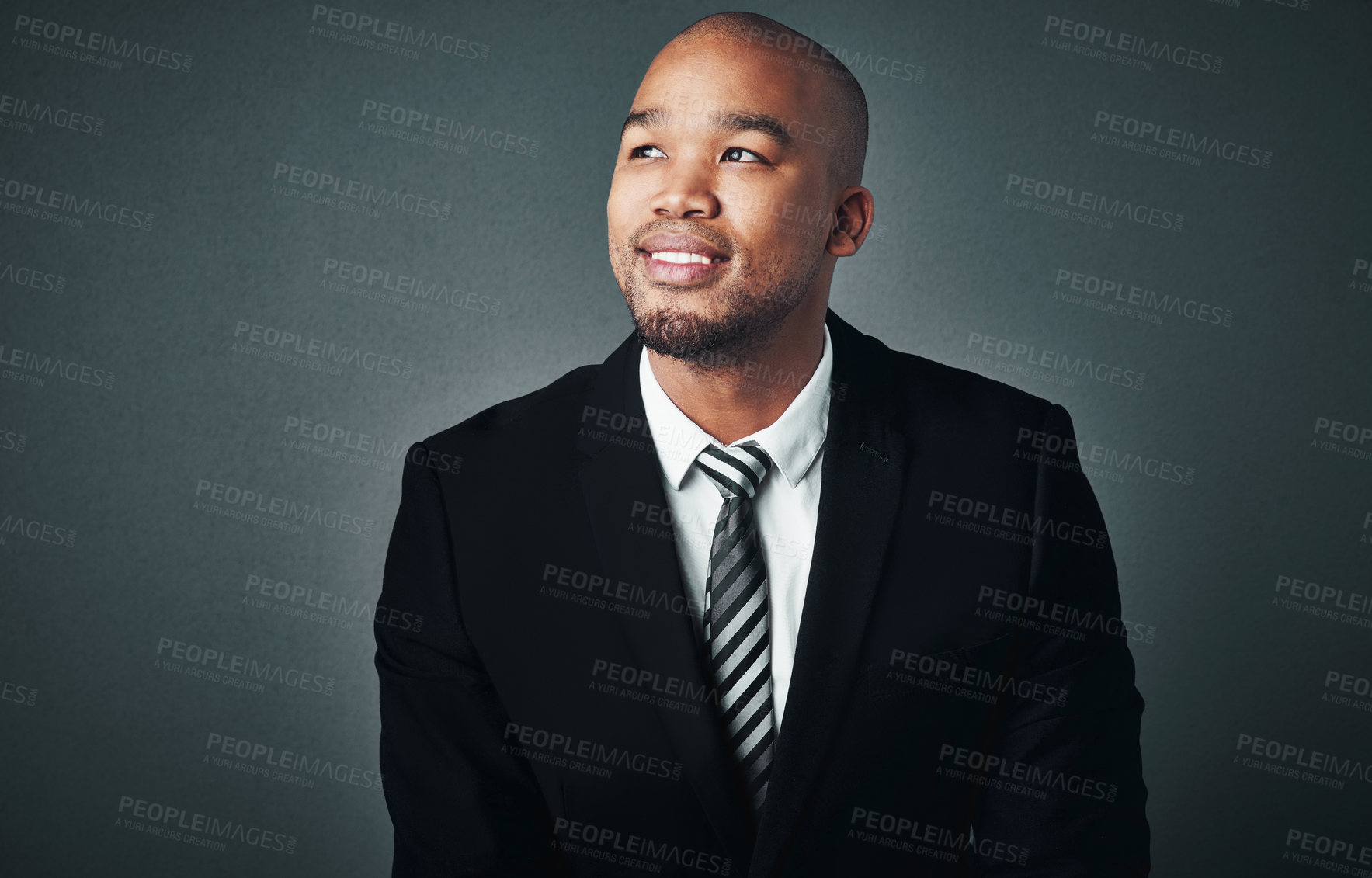 Buy stock photo Studio shot of a handsome young businessman posing against a gray background