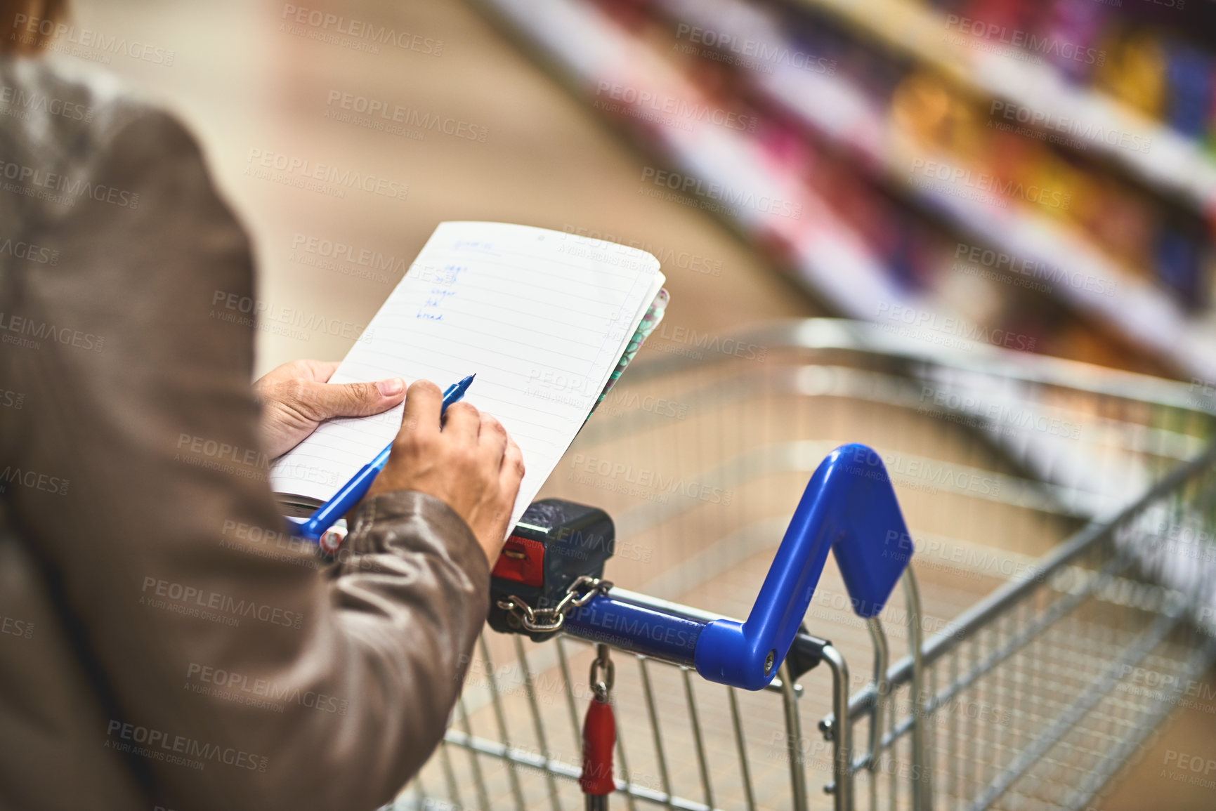 Buy stock photo Hands, person and shopping list at grocery store with wheel cart for foods, products and prices. Closeup, customer and supermarket or convenience shop for retail cost, sale and discount or promotion