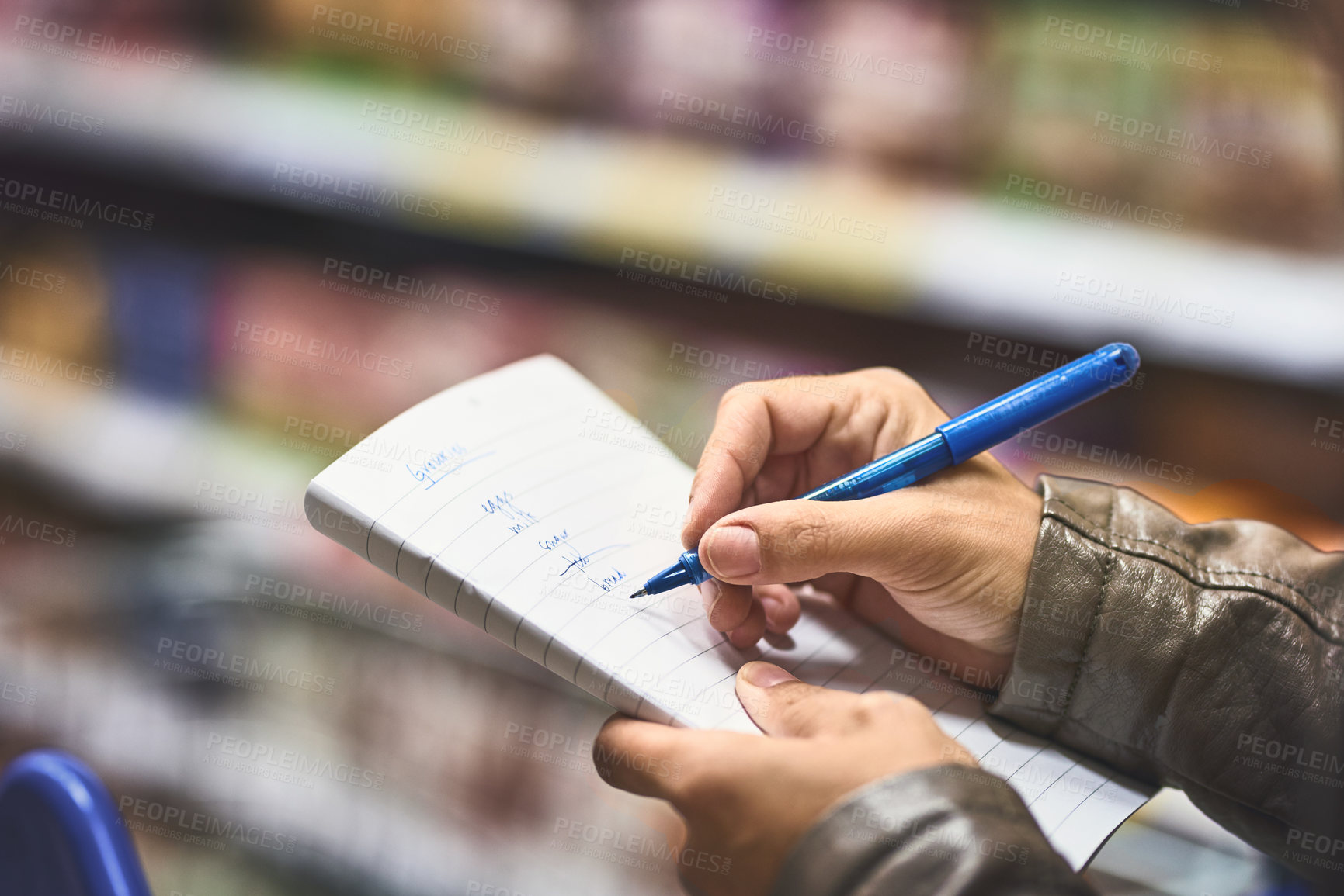 Buy stock photo Hands, person and writing for shopping list at grocery store with wheel cart for food, products and prices. Closeup, customer and supermarket or convenience shop for retail cost, sale and ingredients