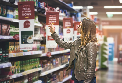 Buy stock photo Shopping, woman at grocery store and in aisle searching and decision for product on a shelf. Customer or consumer, shopper for groceries and female person at supermarket or a shop looking for food