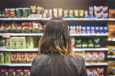 Buy stock photo Rearview shot of a young woman shopping at a grocery store