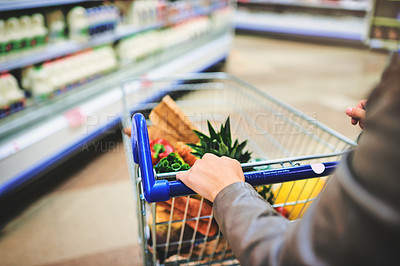 Buy stock photo Woman, trolley and hands for search in supermarket, goods discount and shelves for deal. Female person, sale and shop for options on offer, retail aisle and customer for grocery choice in store