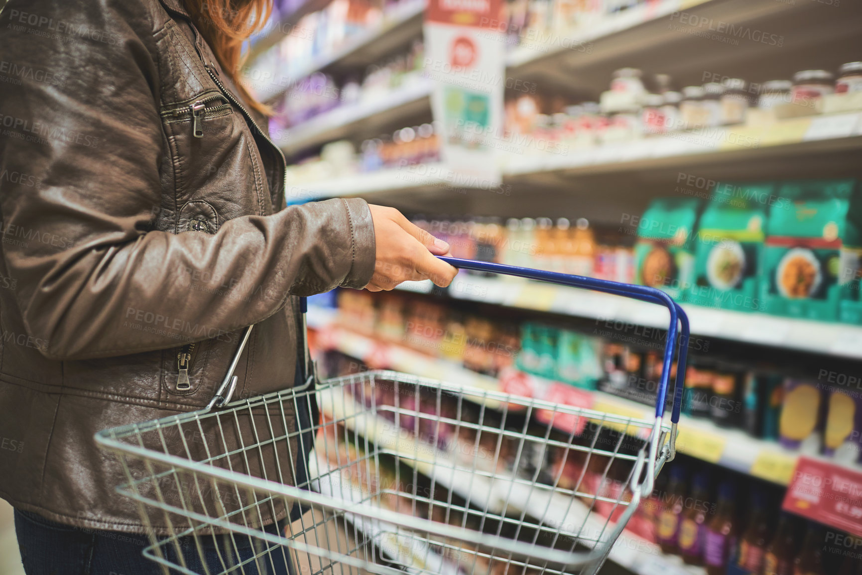 Buy stock photo Basket, hand and shelves of person in grocery store for purchase, retail or shopping closeup. Food, groceries and products with customer person in supermarket for offer, sales price or service