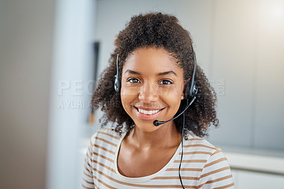 Buy stock photo Portrait of a young woman wearing a headset while working on a computer at home