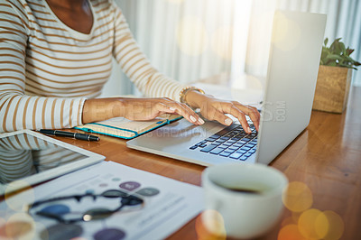 Buy stock photo Closeup shot of an unrecognizable woman working on a laptop at home