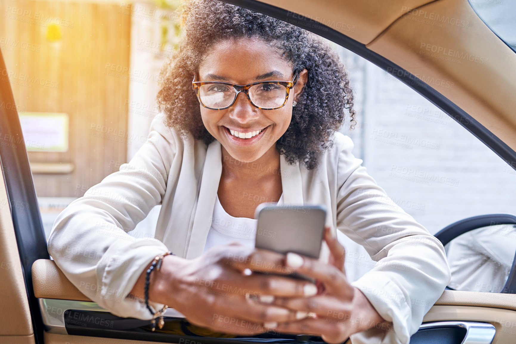 Buy stock photo Happy, portrait and black woman with phone by car for travel service, transportation or commute in city. Young African, female person or tourist with smile on mobile smartphone for drive app in town