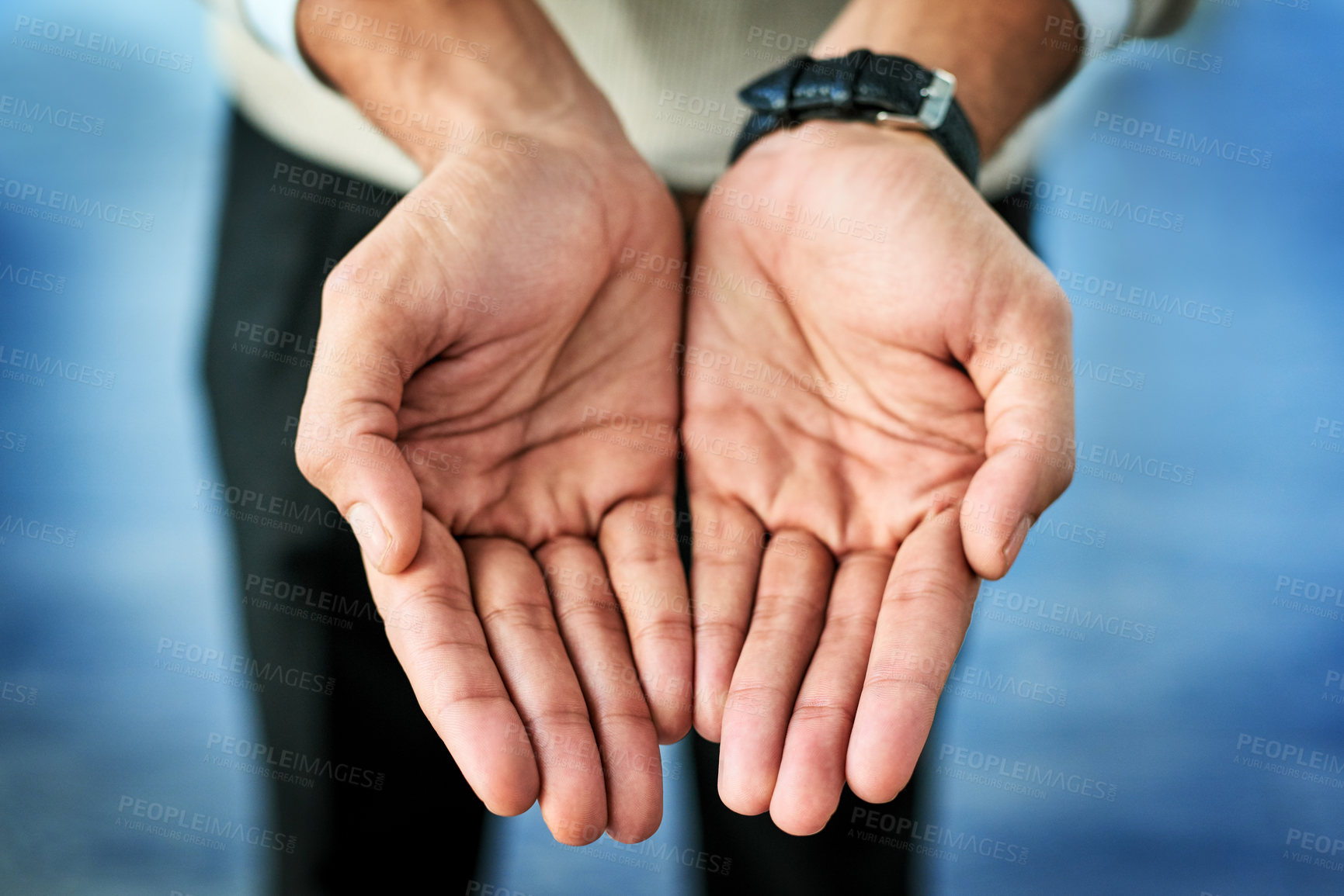 Buy stock photo Closeup of an unrecognizable person reaching out with their open hands against a blue background