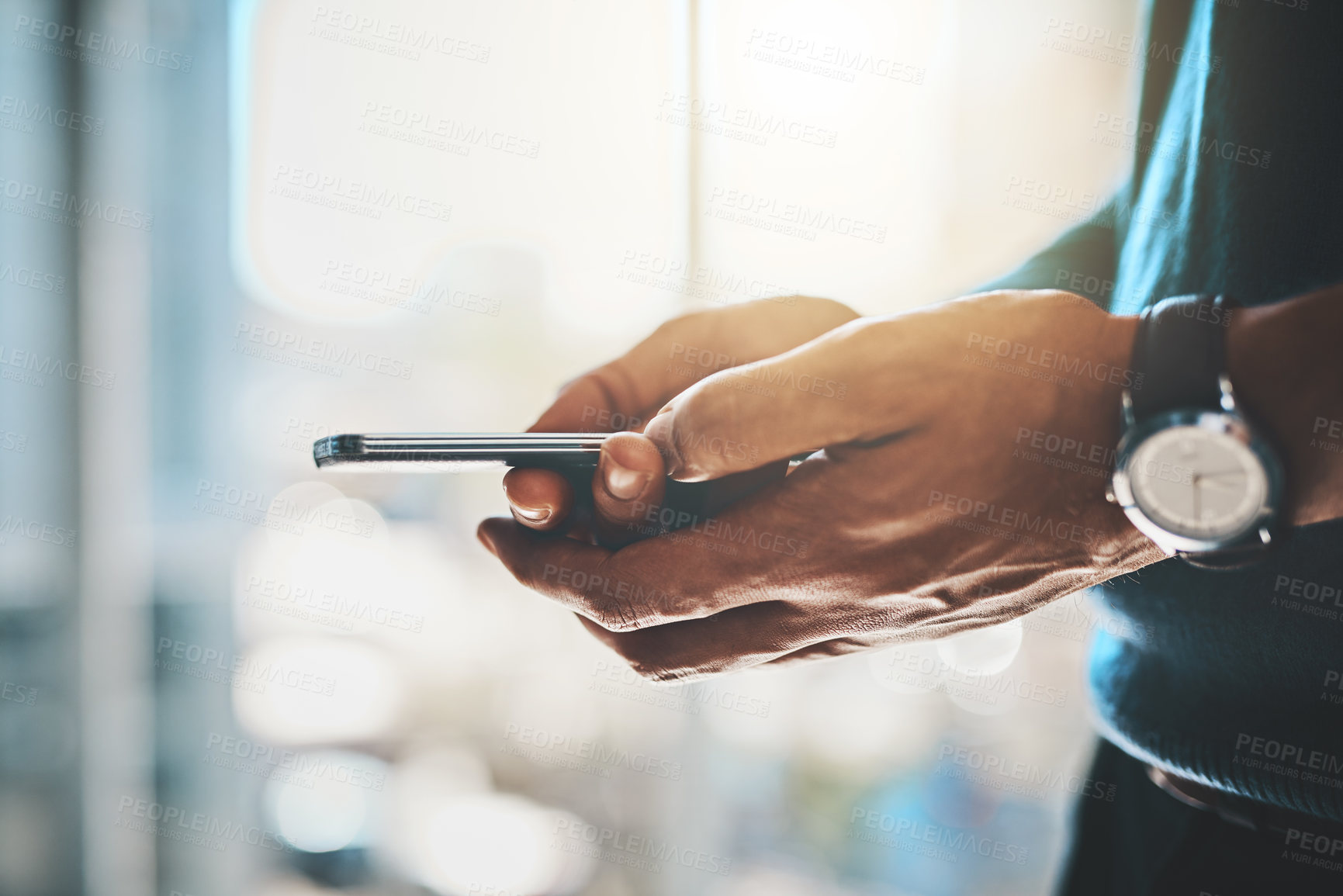 Buy stock photo Cropped shot of a businessman using a mobile phone in an office