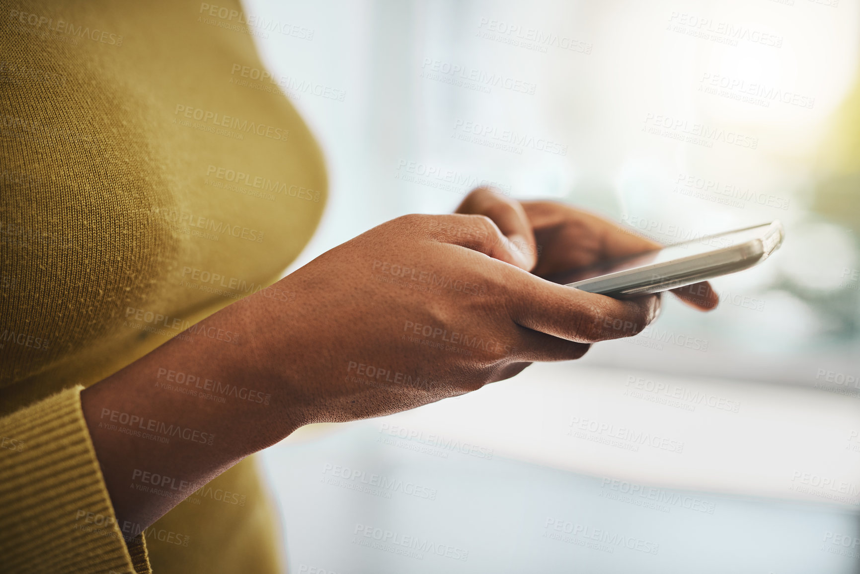 Buy stock photo Cropped shot of a businesswoman using a mobile phone in an office