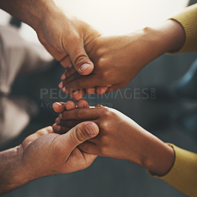 Buy stock photo Cropped shot of a man and woman compassionately holding hands