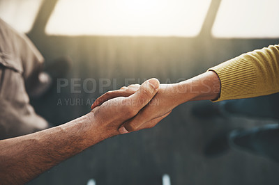 Buy stock photo Cropped shot of a businessman and businesswoman shaking hands