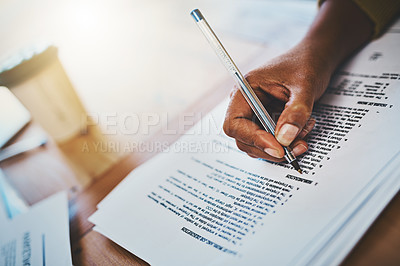 Buy stock photo Cropped shot of a businesswoman completing paperwork at a desk