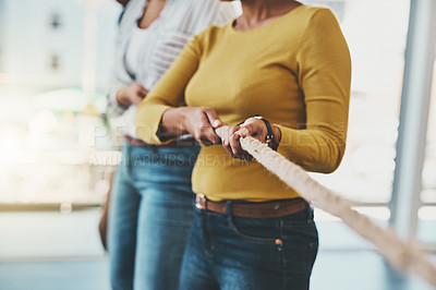 Buy stock photo Closeup shot of two unrecognizable women pulling on a rope
