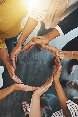 Buy stock photo High angle shot of a group of unidentifiable businesspeople forming a circle with their hands