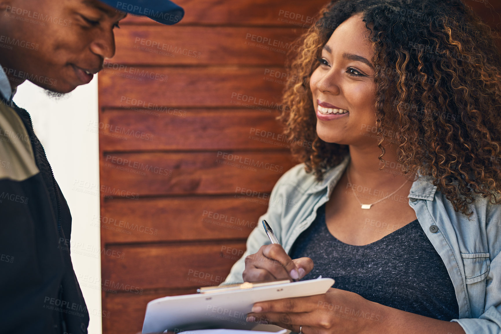 Buy stock photo Happy woman, clipboard and signing with delivery for confirmation, parcel or package at home. Female person with smile for courier guy, signature or shipment in ecommerce or online order by door