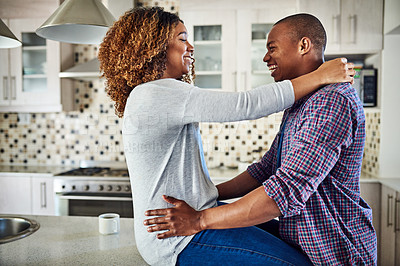 Buy stock photo Cropped shot of an affectionate young couple sharing a loving moment in their kitchen at home