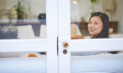 Buy stock photo Cropped portrait of an attractive young woman relaxing with a teddy bear on the sofa at home