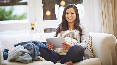 Buy stock photo Portrait of a pregnant woman using a digital tablet at home