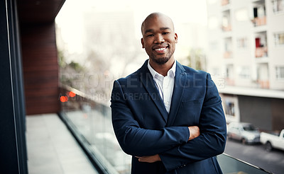 Buy stock photo Portrait of a handsome young businessman standing outside on his office balcony
