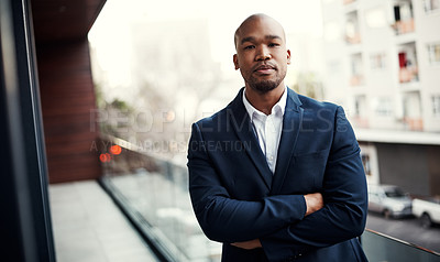 Buy stock photo Portrait of a handsome young businessman standing outside on his office balcony