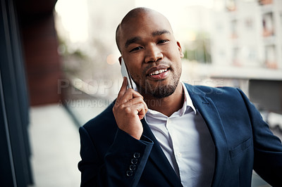 Buy stock photo Portrait of a handsome young businessman talking on a cellphone outside his office