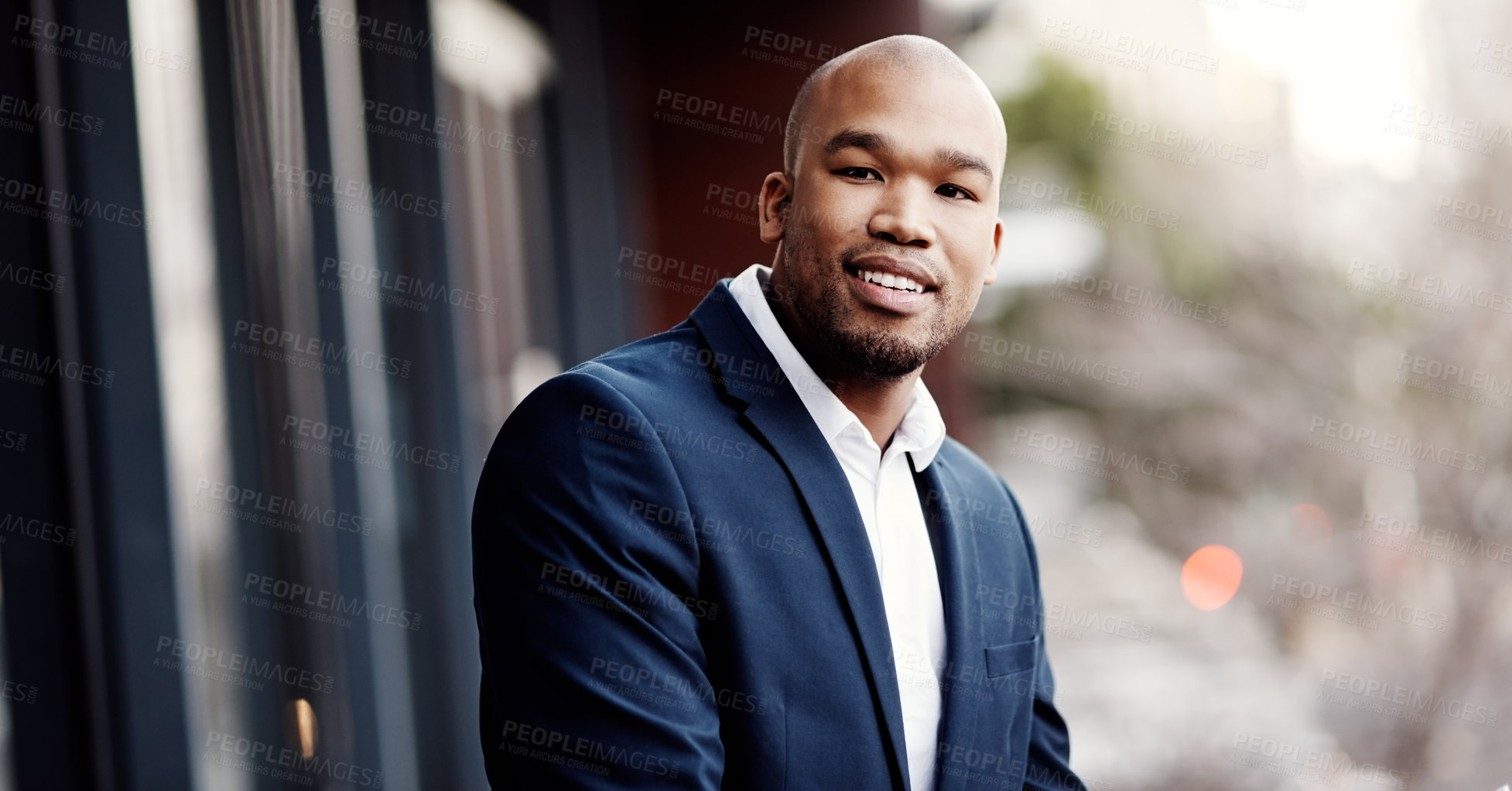 Buy stock photo Portrait of a handsome young businessman standing outside on his office balcony