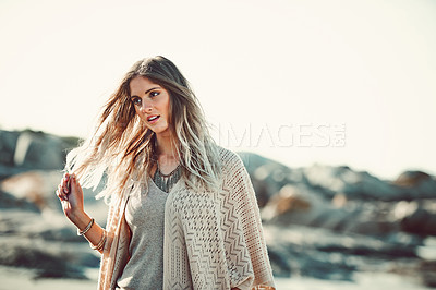 Buy stock photo Shot of an attractive young woman spending a day at the beach