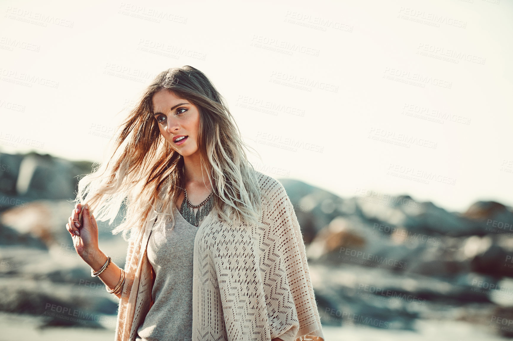 Buy stock photo Shot of an attractive young woman spending a day at the beach