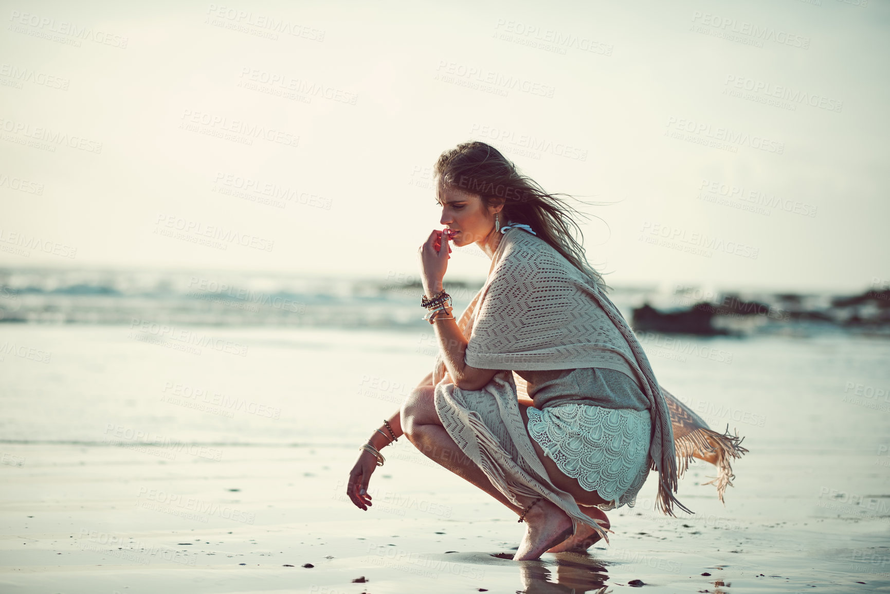 Buy stock photo Shot of an attractive young woman spending a day at the beach