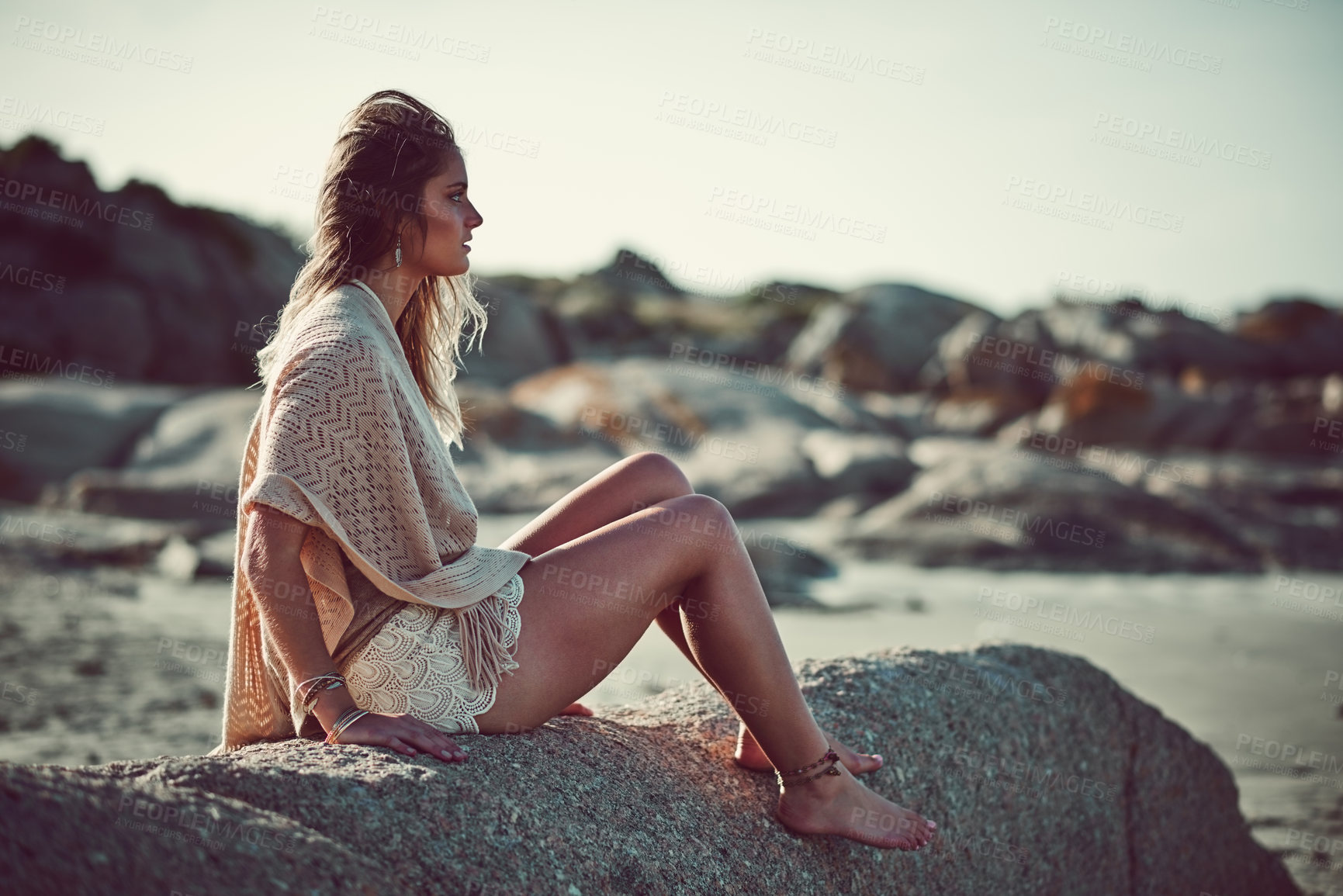 Buy stock photo Shot of an attractive young woman spending a day at the beach