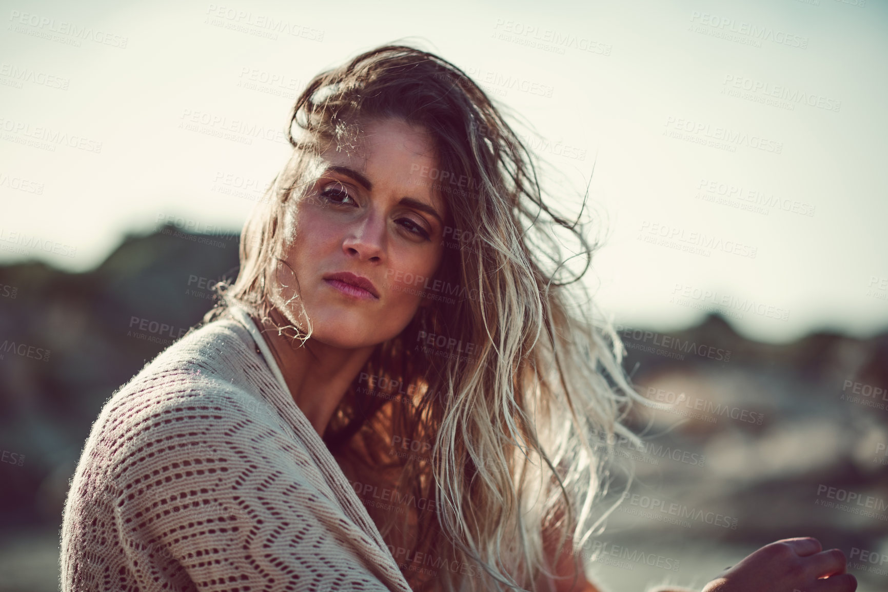 Buy stock photo Shot of an attractive young woman spending a day at the beach