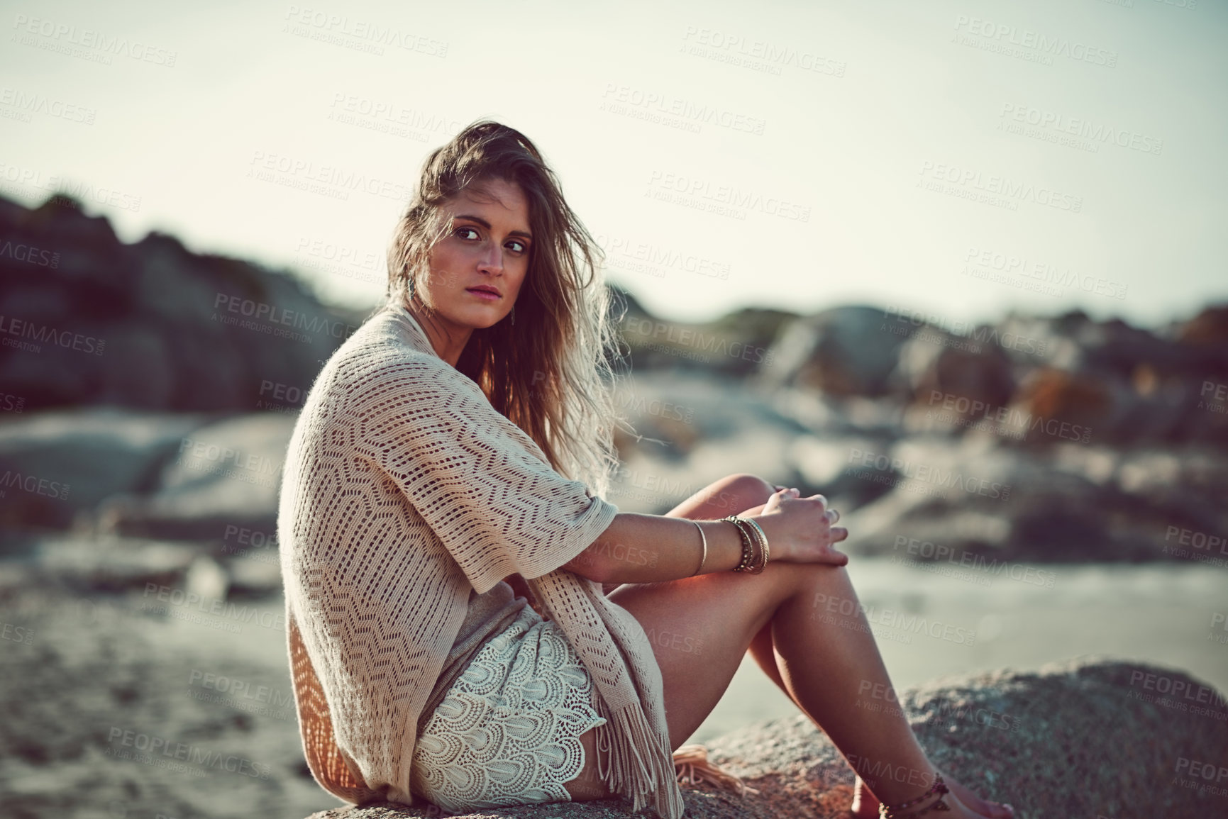 Buy stock photo Shot of an attractive young woman spending a day at the beach