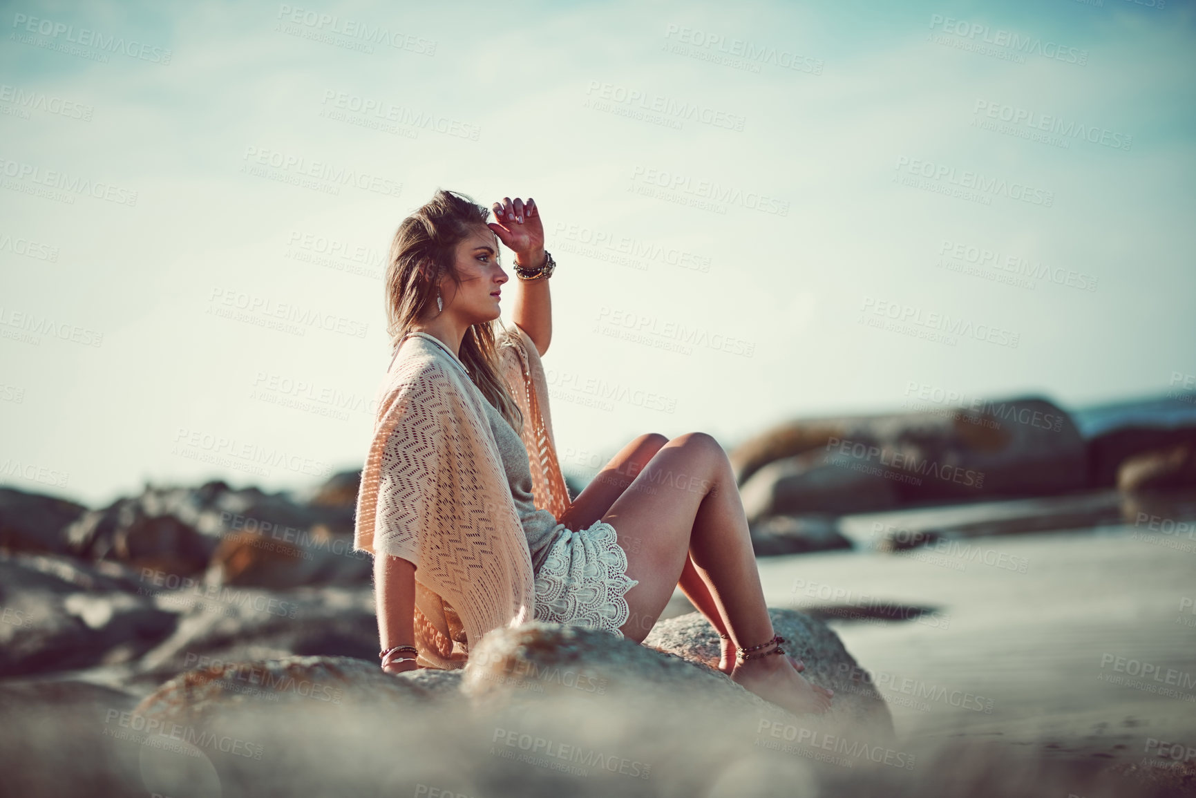 Buy stock photo Shot of an attractive young woman spending a day at the beach