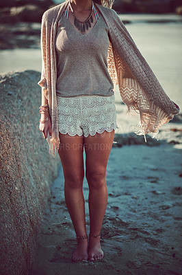 Buy stock photo Cropped shot of an unrecognizable woman spending a day at the beach