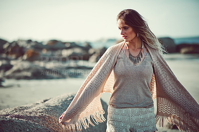 Buy stock photo Shot of an attractive young woman spending a day at the beach