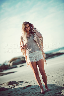 Buy stock photo Shot of an attractive young woman spending a day at the beach