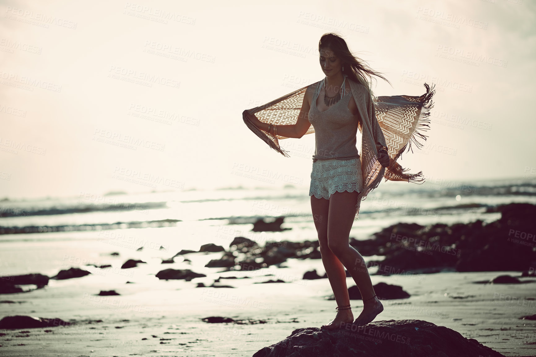 Buy stock photo Shot of an attractive young woman spending a day at the beach