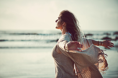 Buy stock photo Shot of an attractive young woman spending a day at the beach