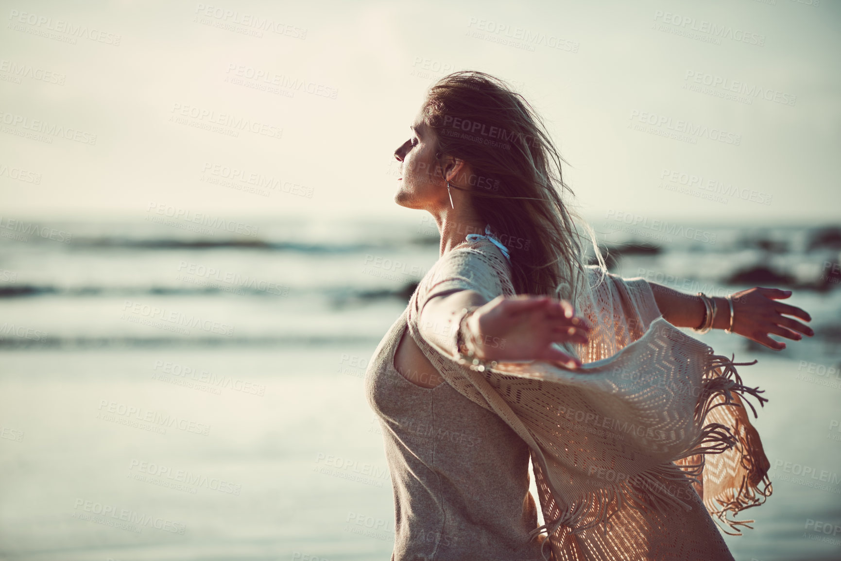 Buy stock photo Shot of an attractive young woman spending a day at the beach