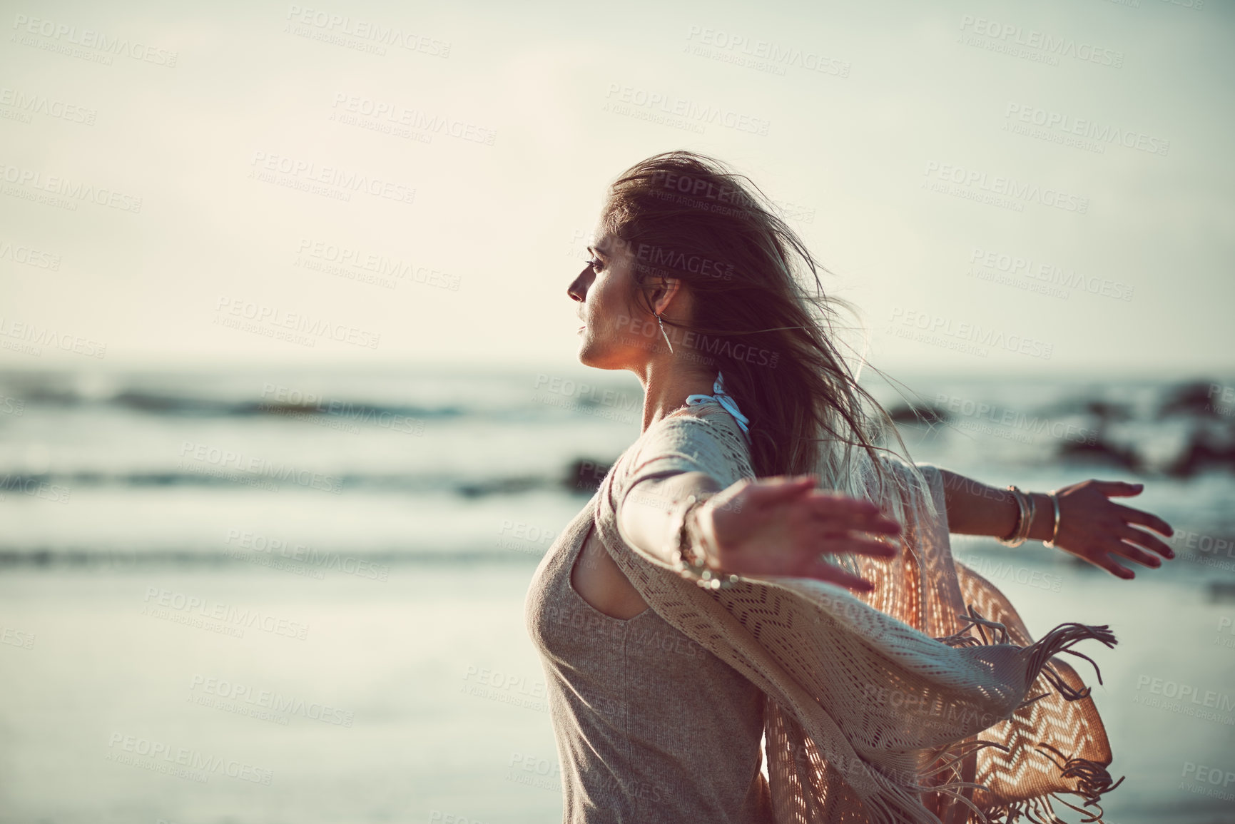 Buy stock photo Shot of an attractive young woman spending a day at the beach