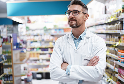 Buy stock photo Shot of a confident mature pharmacist working in a pharmacy