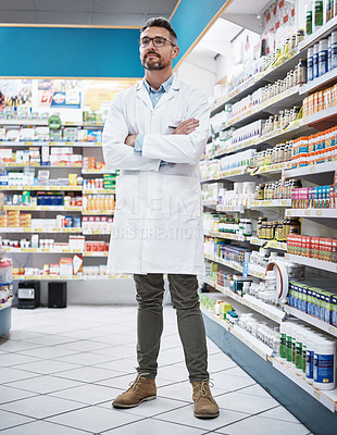 Buy stock photo Shot of a confident mature pharmacist working in a pharmacy