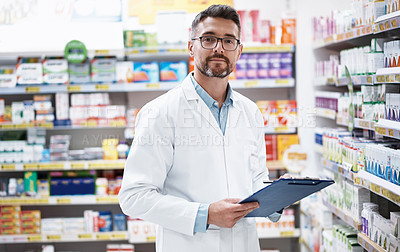 Buy stock photo Portrait of a mature pharmacist doing inventory in a pharmacy