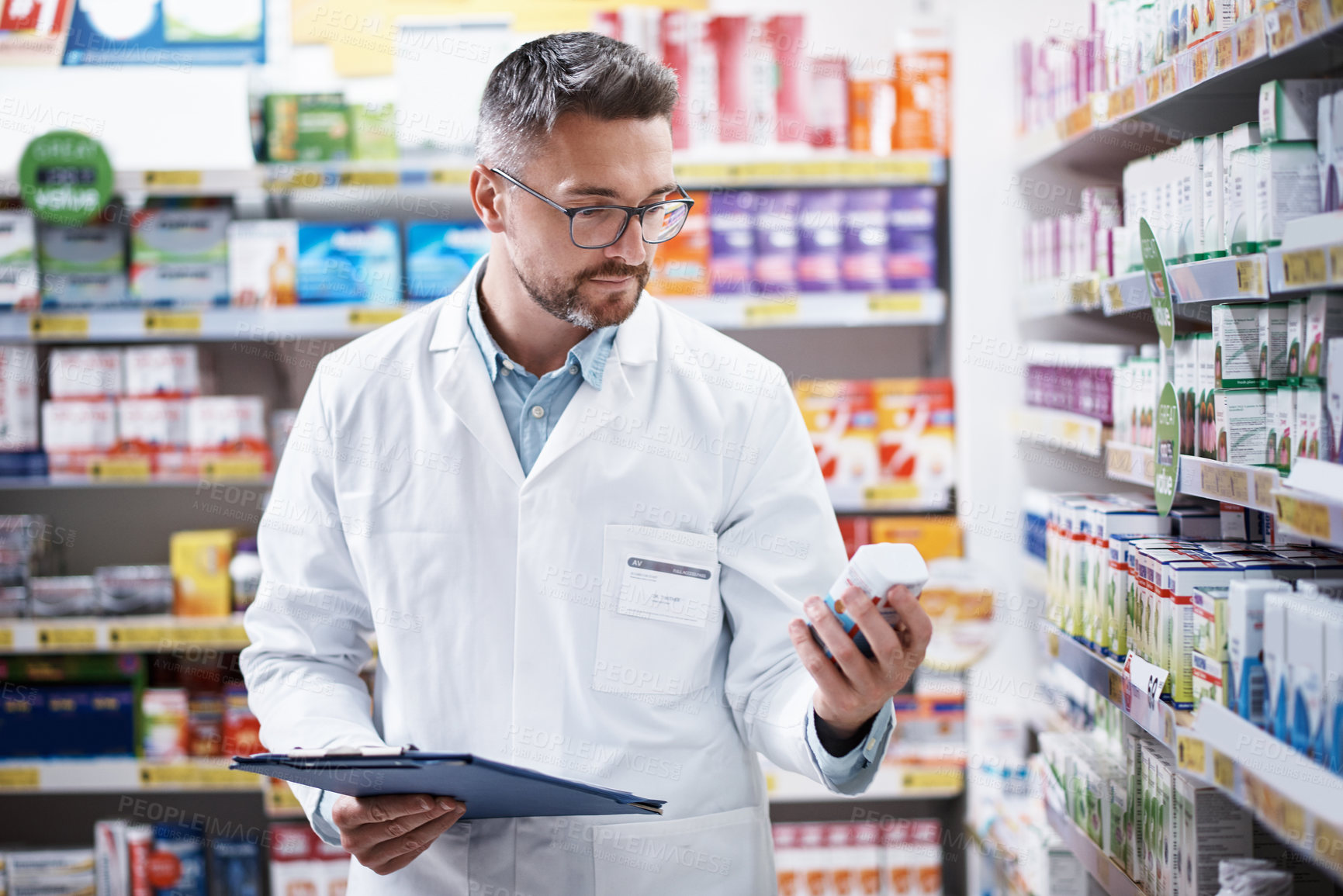 Buy stock photo Pharmacist, man or clipboard with medication inspection for inventory check, label info or expiry date. Drugs expert, mature person and stock count with checklist for quality assurance and compliance