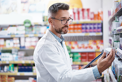 Buy stock photo Shot of a mature pharmacist doing inventory in a pharmacy