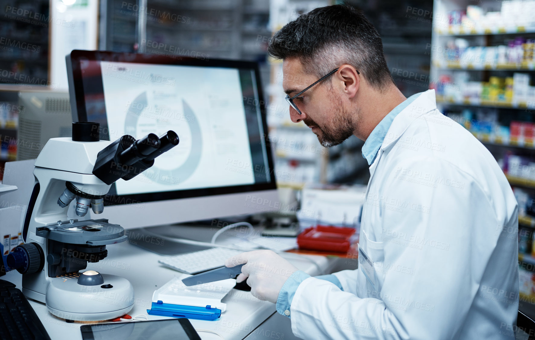 Buy stock photo Shot of a mature pharmacist counting medication