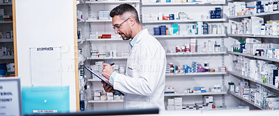 Buy stock photo Shot of a mature pharmacist doing inventory in a pharmacy