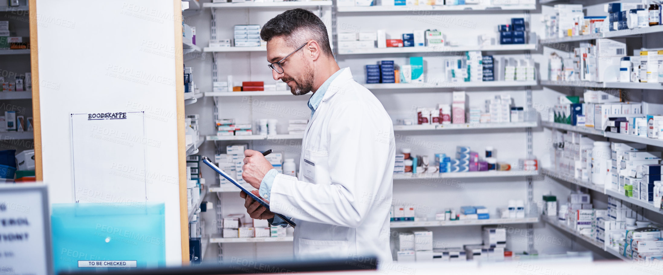 Buy stock photo Shot of a mature pharmacist doing inventory in a pharmacy