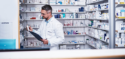 Buy stock photo Shot of a mature pharmacist doing inventory in a pharmacy