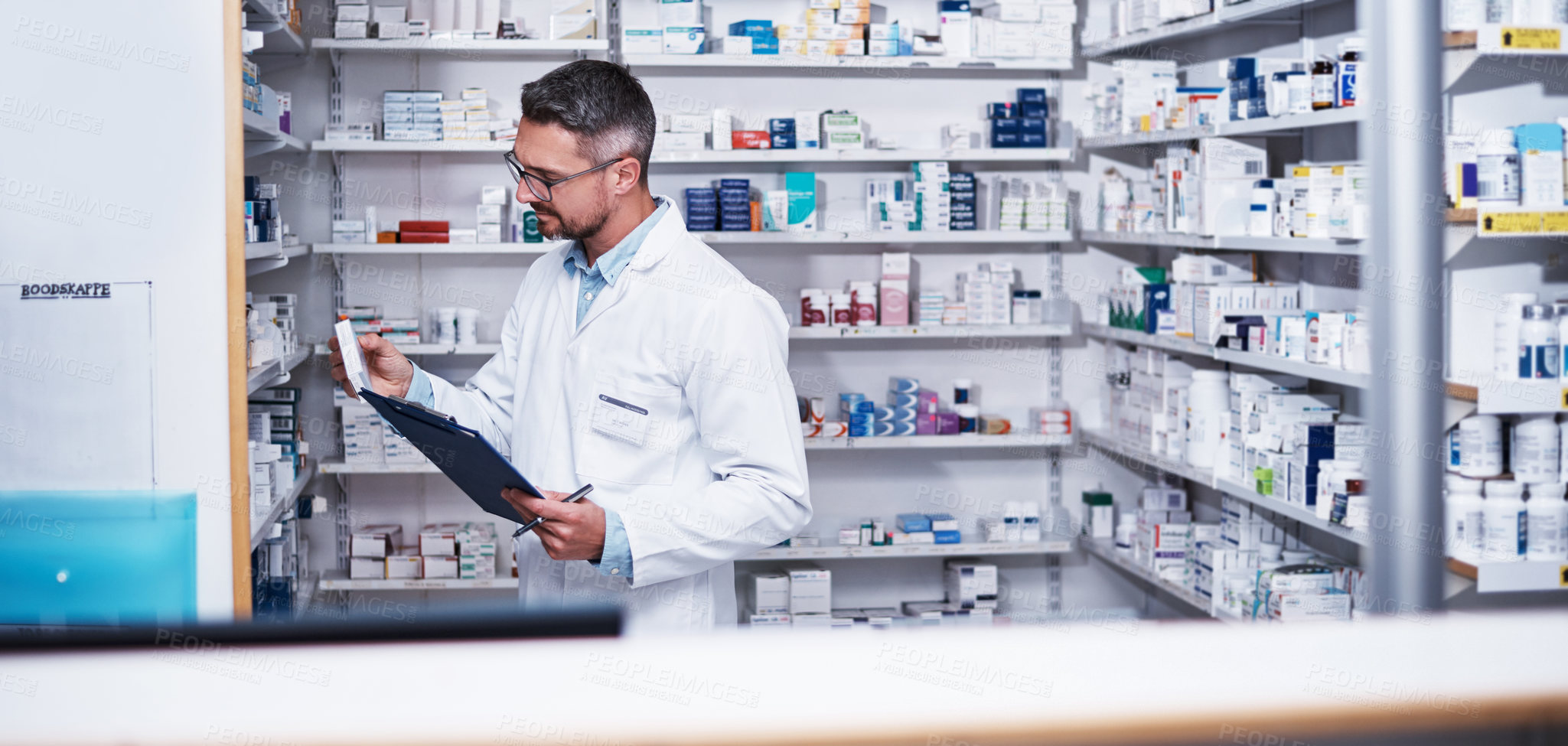 Buy stock photo Shot of a mature pharmacist doing inventory in a pharmacy